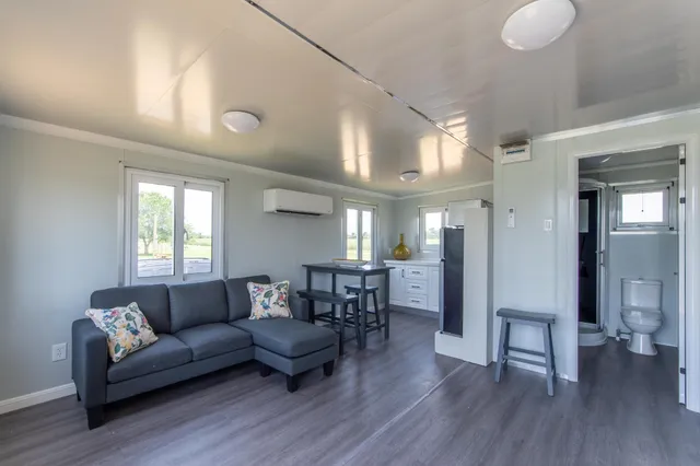 a view of a livingroom with furniture and a dining table