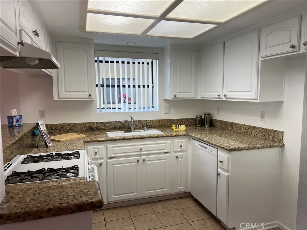 3516 East Ransom Street, Unit 204 Long Beach, CA 90804 - Photo 12 of 38 a kitchen with a sink stove and cabinets
