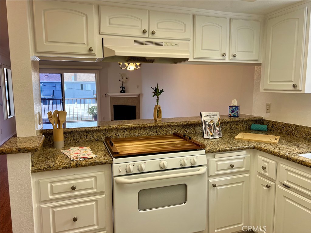 3516 East Ransom Street, Unit 204 Long Beach, CA 90804 - Photo 13 of 38 a kitchen with granite countertop a sink stainless steel appliances and cabinets
