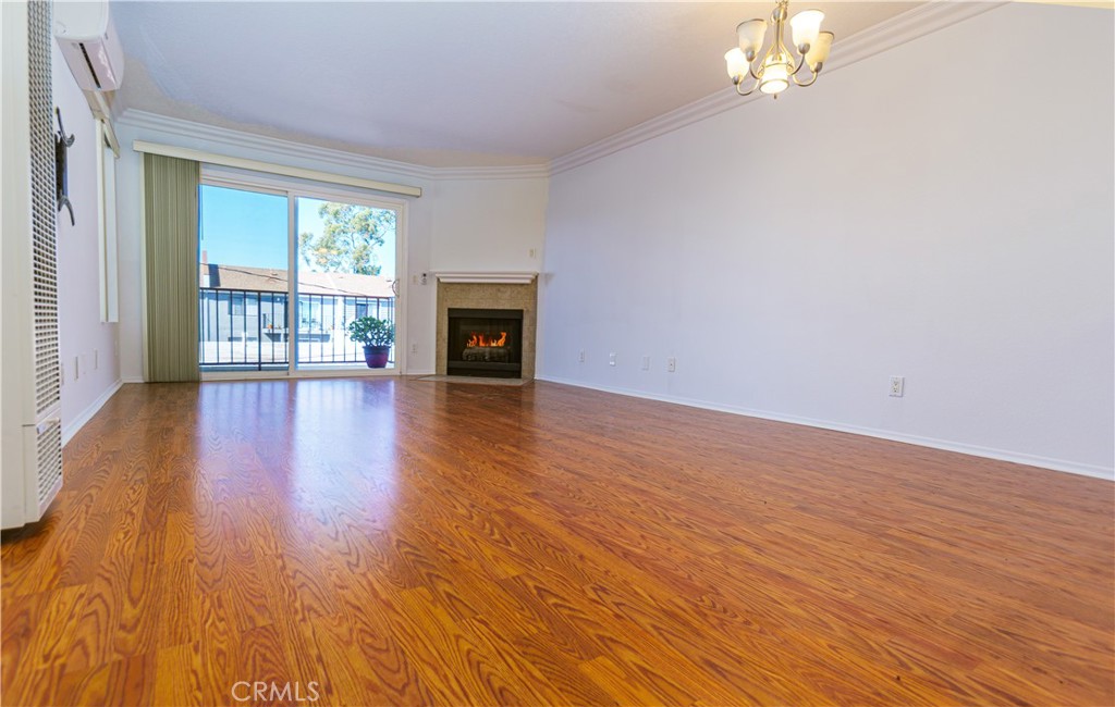3516 East Ransom Street, Unit 204 Long Beach, CA 90804 - Photo 2 of 38 a view of an empty room with wooden floor and a window