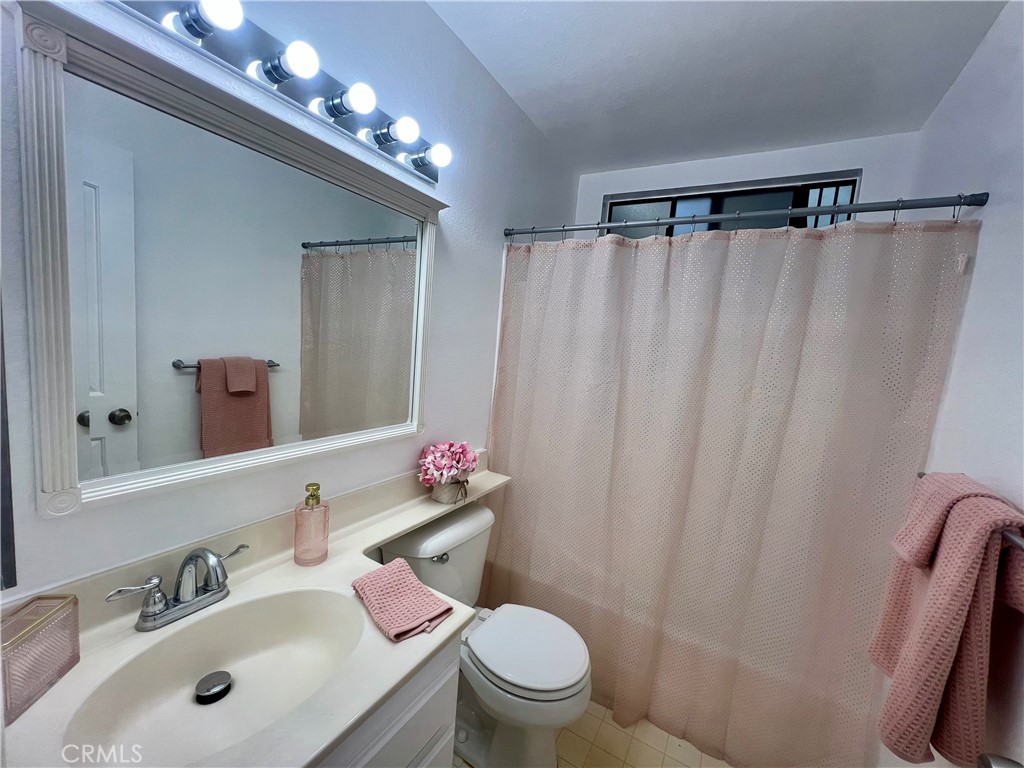 3516 East Ransom Street, Unit 204 Long Beach, CA 90804 - Photo 21 of 38 a bathroom with a sink vanity mirror and toilet