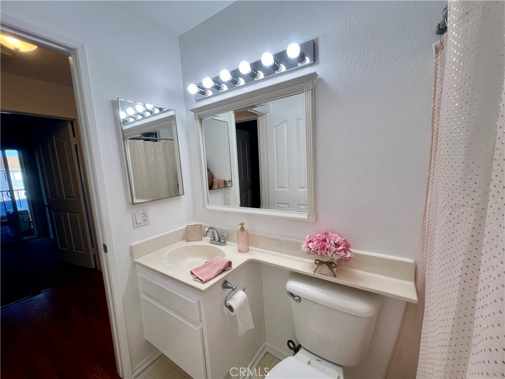 3516 East Ransom Street, Unit 204 Long Beach, CA 90804 - Photo 23 of 38 a bathroom with a sink vanity and mirror