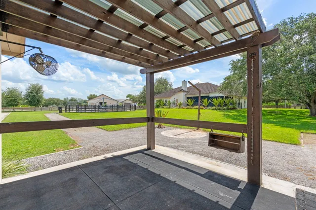 a living room with furniture a fireplace and a chandelier