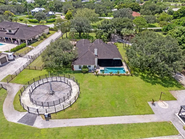a living room with furniture kitchen view and a chandelier