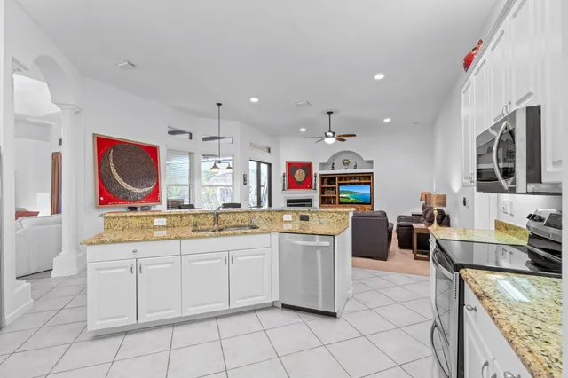 a bedroom with a bed a mirror and a large window