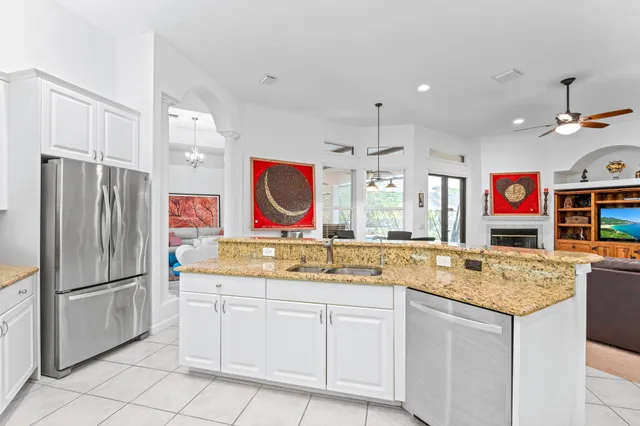 a living room with furniture a rug and a wall painting