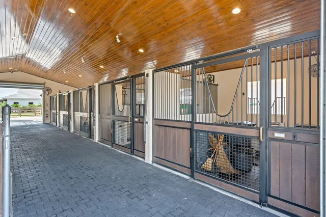 a kitchen with stainless steel appliances granite countertop a refrigerator a stove and a sink