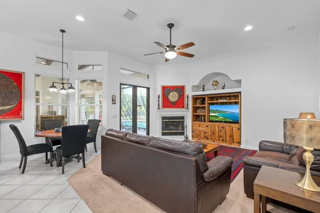 a dining room with furniture a chandelier and fireplace