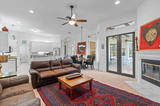 a bedroom with a bed chandelier and a window