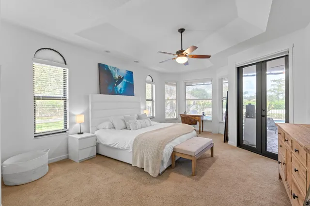 a bedroom with a bed and a chandelier