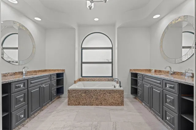 an aerial view of residential houses with outdoor space and trees