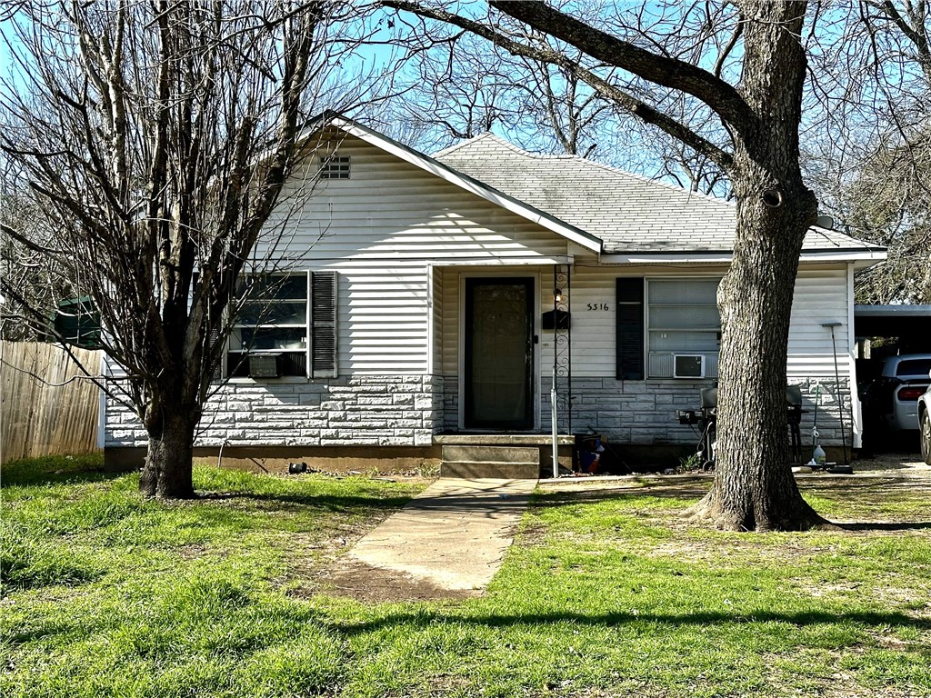 a view of a house with yard and sitting area
