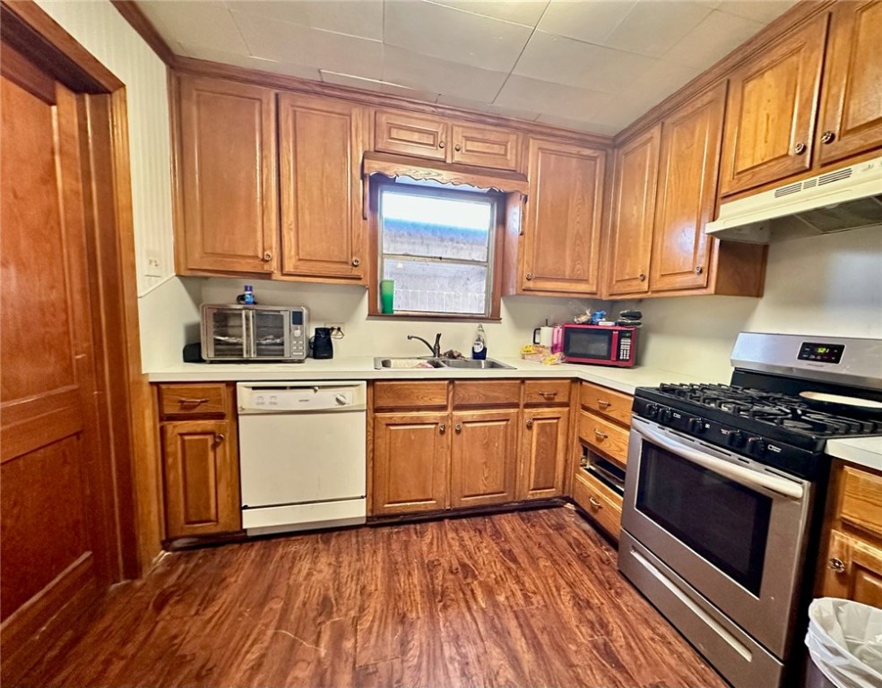 3316 North 21st Street Waco, TX 76708 - Photo 2 of 6 a kitchen with wooden floors and white appliances