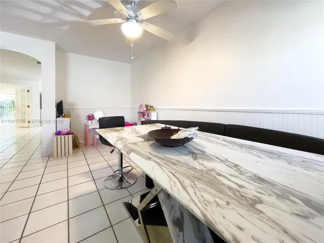 a view of a workspace with a table and chairs