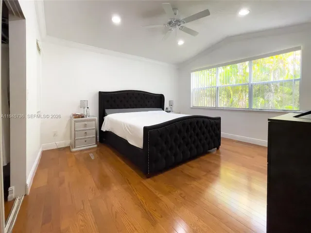 a spacious bedroom with a bed and a large window