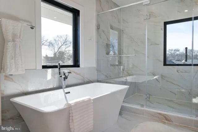 a white toilet sitting next to a bath tub