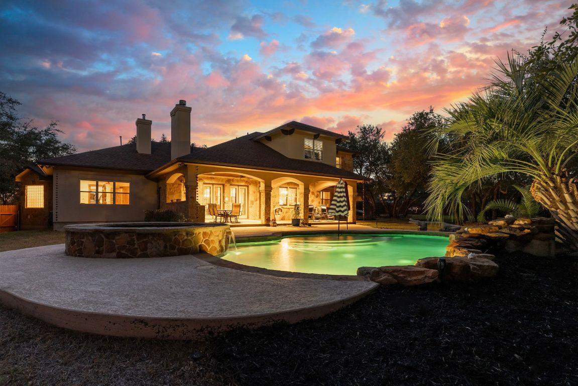 a view of a house with swimming pool and garden
