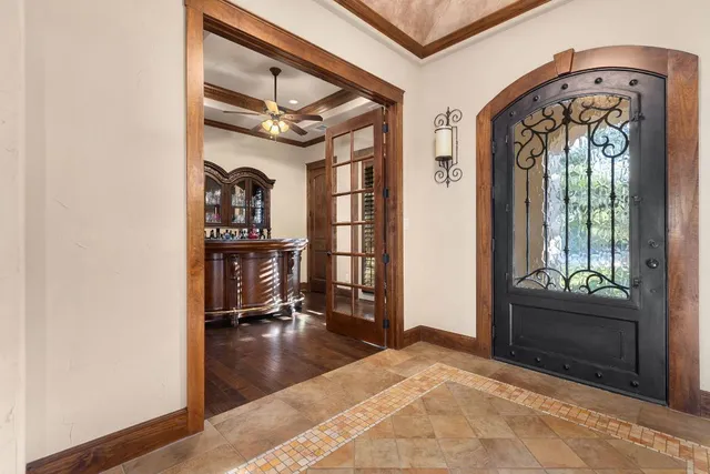 a view of a hallway with dining area and chandelier