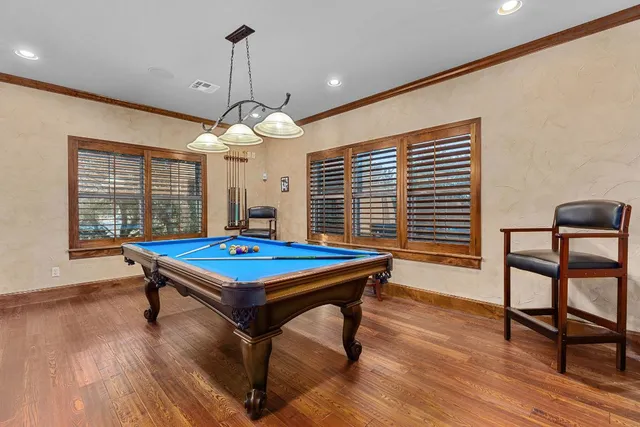 a living room with furniture a large window and flat screen tv