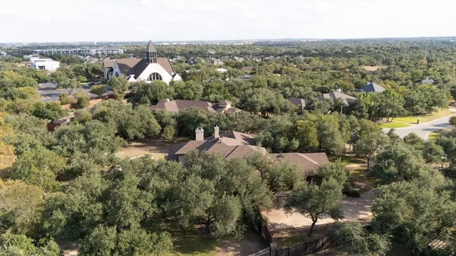 an aerial view of a house with a yard