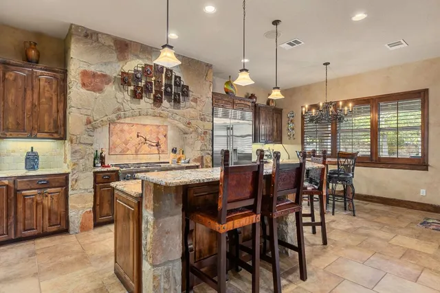 a large kitchen with stainless steel appliances and a stove