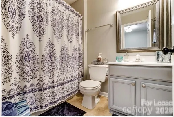a bathroom with a toilet sink and a mirror
