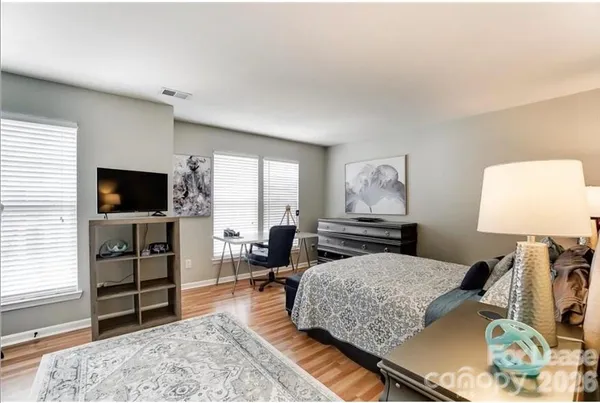 a bedroom with furniture and a flat screen tv