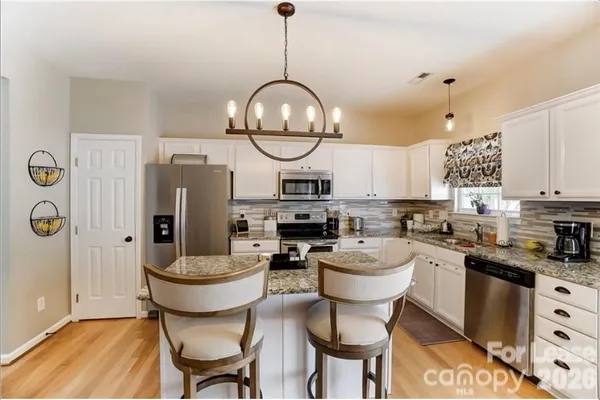 a kitchen with a dining table and chairs