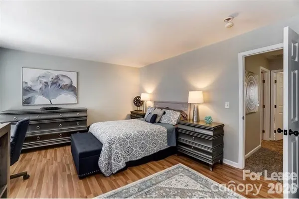 a bedroom with furniture and wooden floor