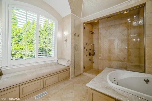 a bathroom with a bathtub and a shower