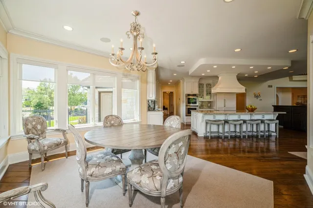 a dining room with furniture window and wooden floor