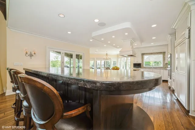 a dining hall with stainless steel appliances granite countertop a granite counter tops and a view of living room