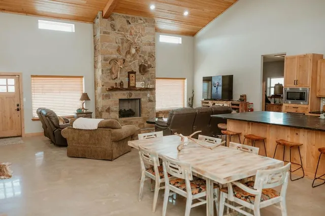 a living room with furniture a fireplace and a chandelier
