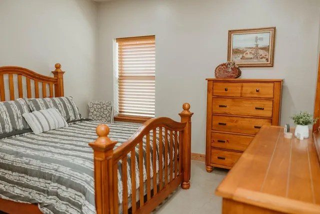 a bedroom with a bed and a window