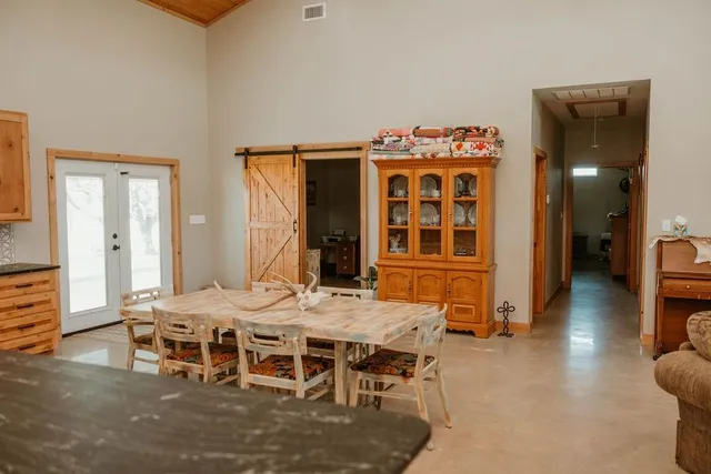 a kitchen with stainless steel appliances granite countertop a refrigerator a stove and a sink with wooden floor