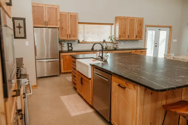 a kitchen with stainless steel appliances a sink and cabinets