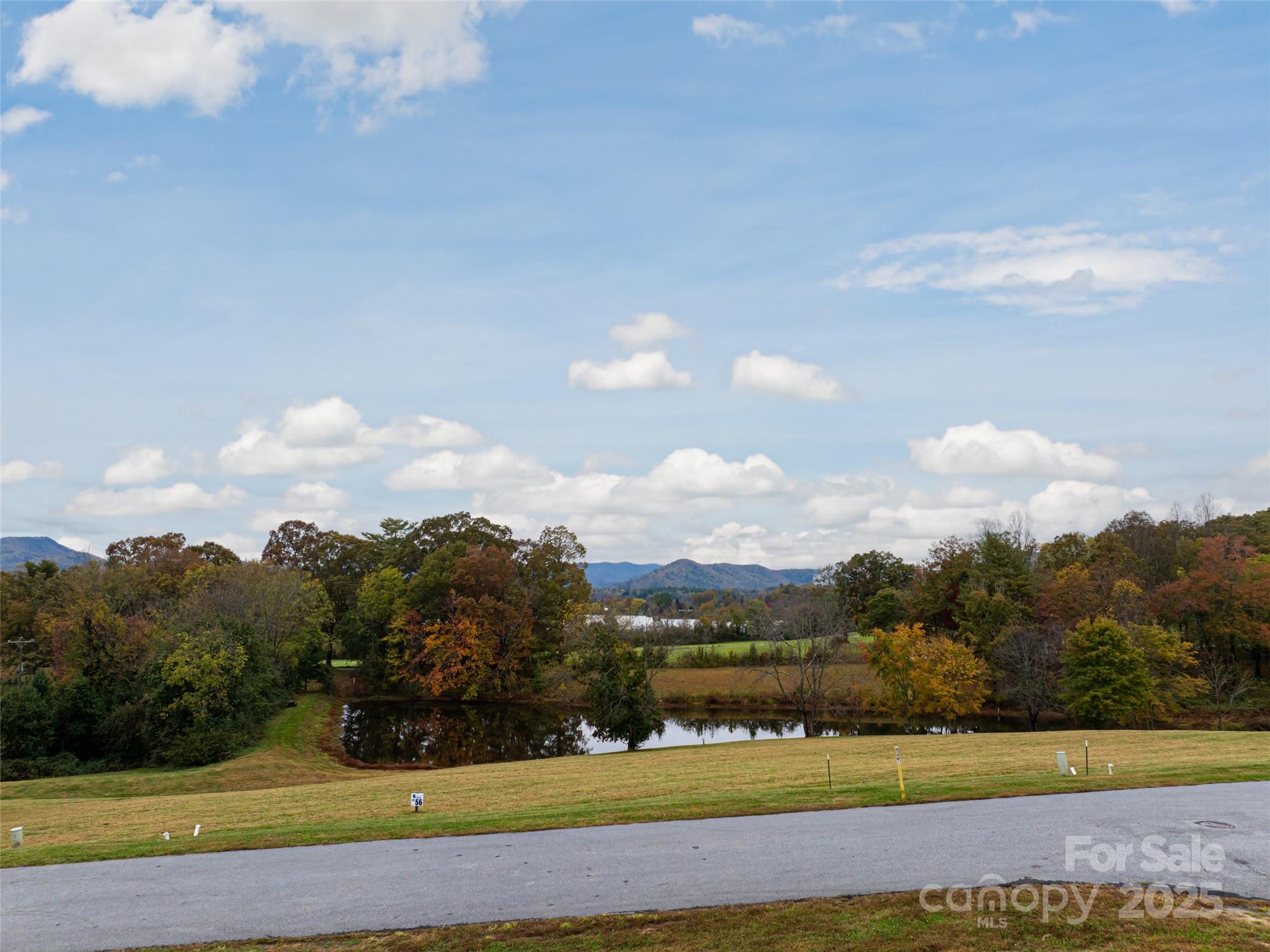 301 Majestic Ridge Road, Unit 57 Mills River, NC 28759 - Photo 19 of 25 a view of a lake with houses in back