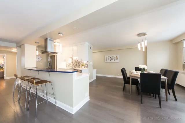 3180 North Lake Shore Drive, Unit 17E Chicago, IL 60657 - Photo 14 of 38 a view of a dining room with furniture and a chandelier