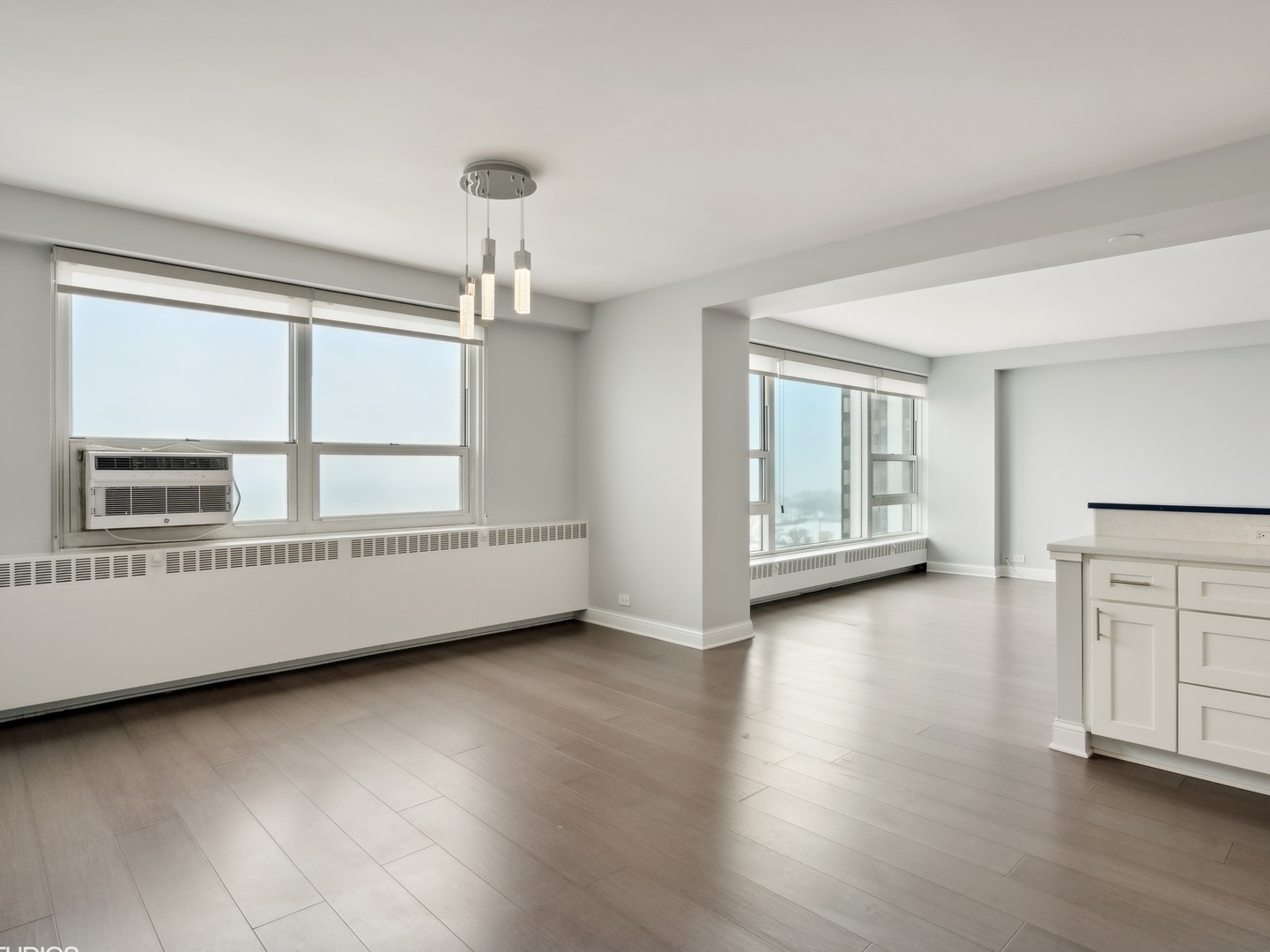 3180 North Lake Shore Drive, Unit 17E Chicago, IL 60657 - Photo 15 of 38 a view of an empty room with a window and wooden floor