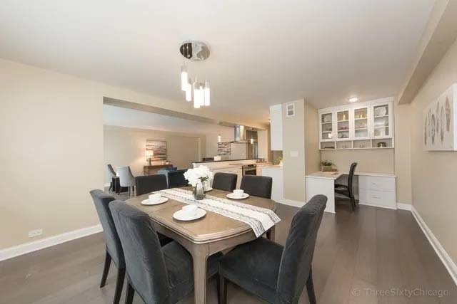 3180 North Lake Shore Drive, Unit 17E Chicago, IL 60657 - Photo 16 of 38 a view of a dining room with furniture and wooden floor