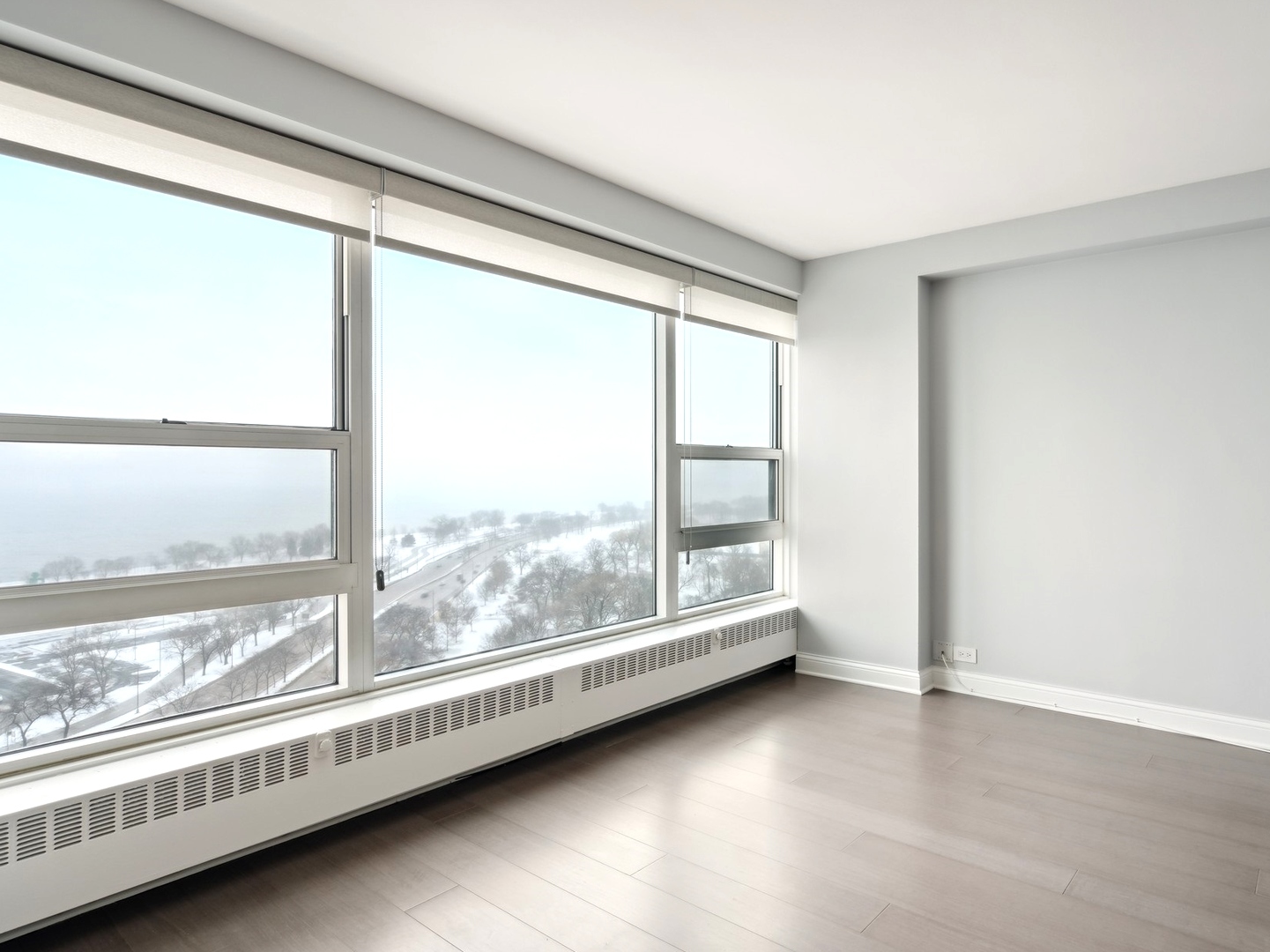3180 North Lake Shore Drive, Unit 17E Chicago, IL 60657 - Photo 19 of 38 a view of an empty room with a large window
