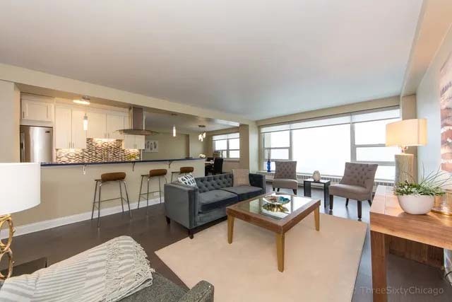 3180 North Lake Shore Drive, Unit 17E Chicago, IL 60657 - Photo 21 of 38 a living room with furniture and a large window