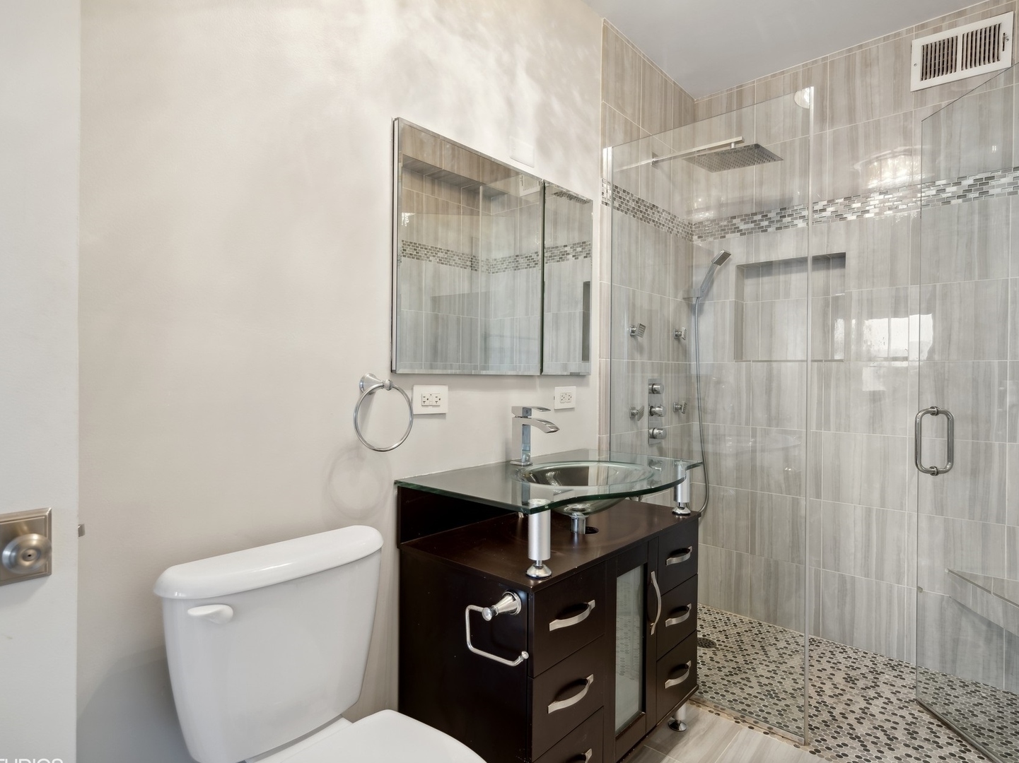 3180 North Lake Shore Drive, Unit 17E Chicago, IL 60657 - Photo 22 of 38 a bathroom with a sink a toilet a mirror and shower
