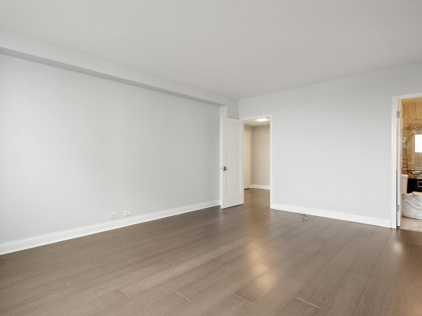 3180 North Lake Shore Drive, Unit 17E Chicago, IL 60657 - Photo 27 of 38 a view of an empty room and wooden floor