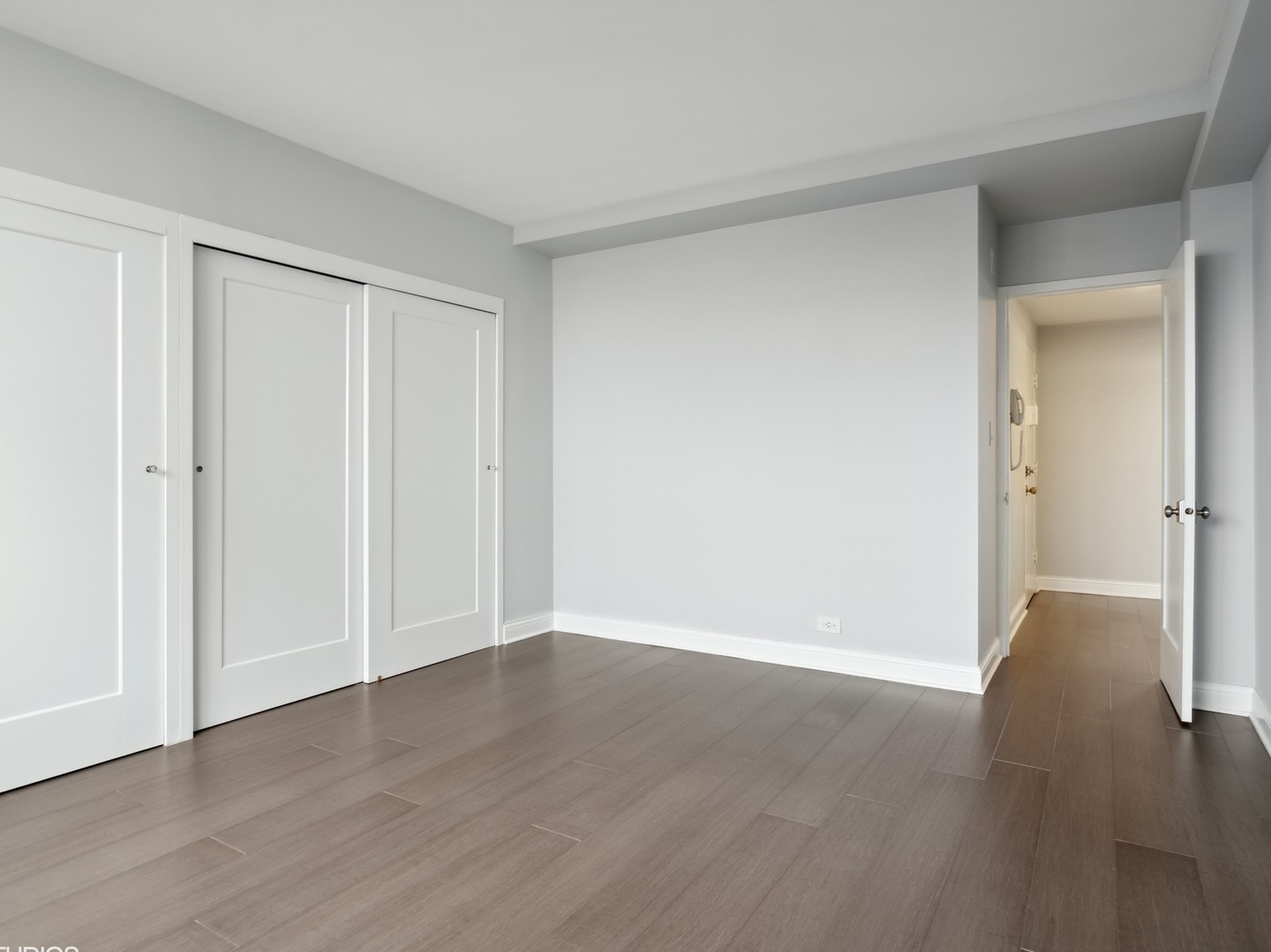3180 North Lake Shore Drive, Unit 17E Chicago, IL 60657 - Photo 31 of 38 a view of an empty room with wooden floor