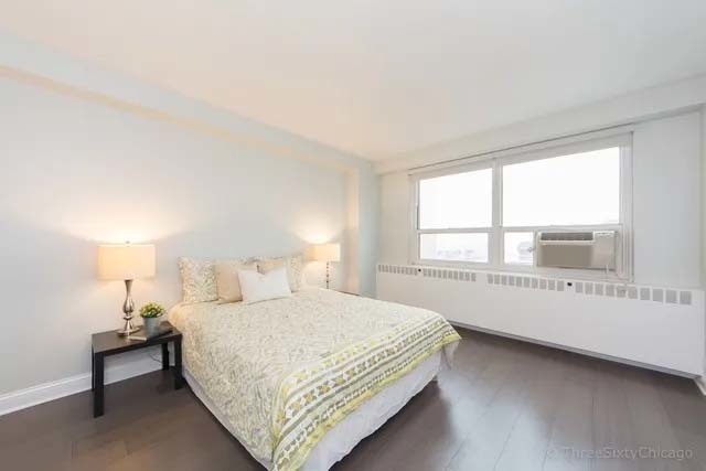 3180 North Lake Shore Drive, Unit 17E Chicago, IL 60657 - Photo 33 of 38 a bedroom with a bed and a large window