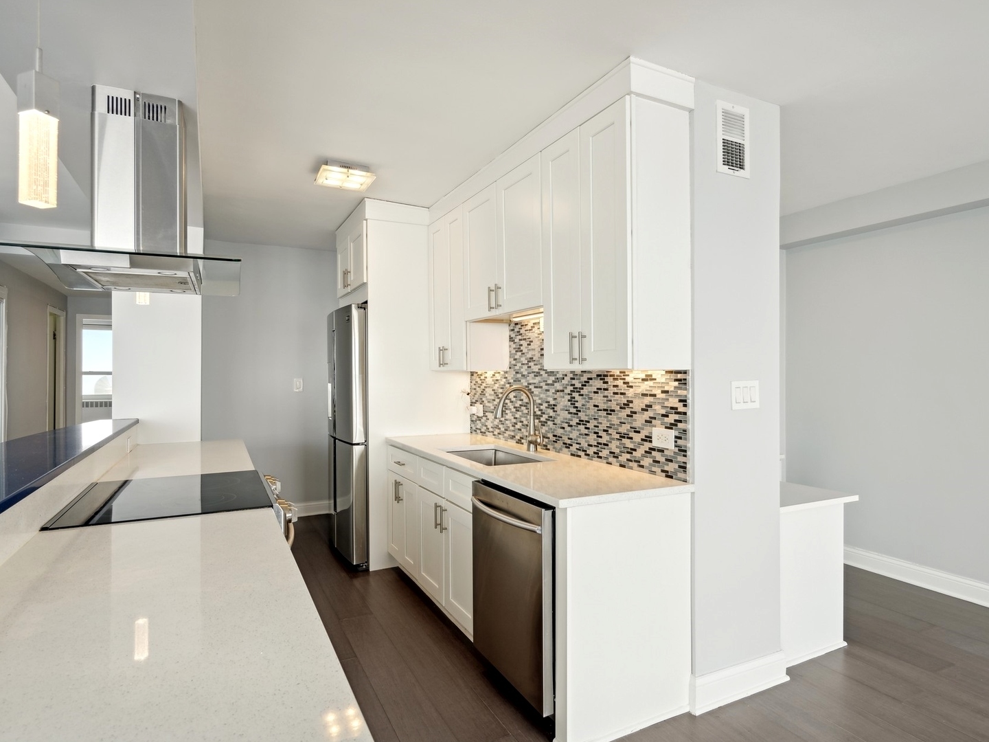 3180 North Lake Shore Drive, Unit 17E Chicago, IL 60657 - Photo 5 of 38 a kitchen with stainless steel appliances kitchen island granite countertop a refrigerator and a stove