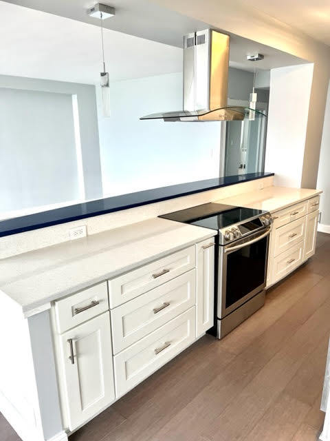 3180 North Lake Shore Drive, Unit 17E Chicago, IL 60657 - Photo 8 of 38 a kitchen with white cabinets and white appliances