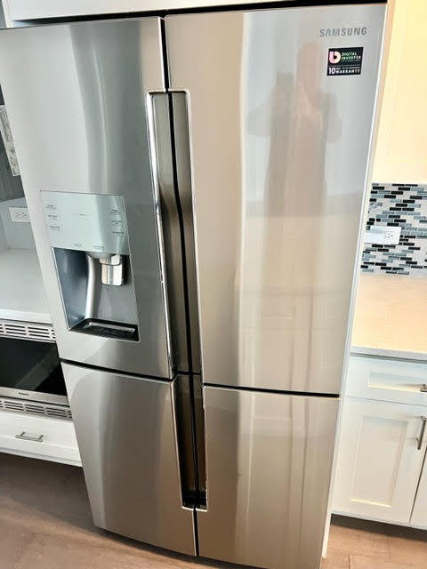 3180 North Lake Shore Drive, Unit 17E Chicago, IL 60657 - Photo 9 of 38 a view of a refrigerator in kitchen and an empty room with wooden floor