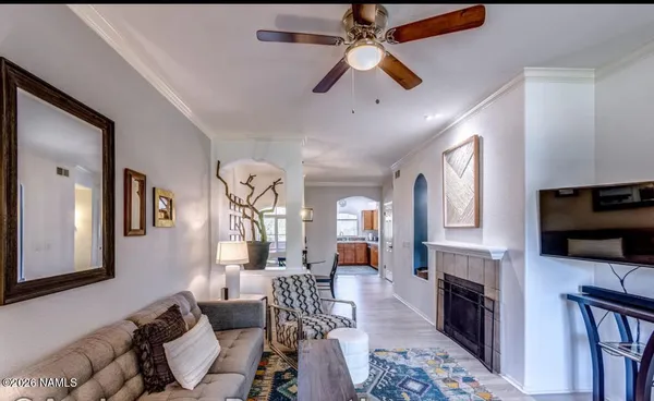 a living room with furniture a fireplace and a flat screen tv